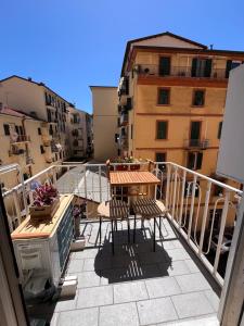 a balcony with a table and chairs on a building at Little House 5 Terre in La Spezia