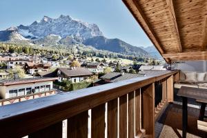 a balcony with a view of a mountain at Deluxe Apartment Zugspitze Ehrwald mit Pool, Sauna, direkt am Golfplatz in Ehrwald