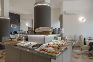 a buffet line with many different types of food at Hotel Continental in Caorle