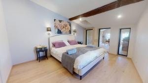 a bedroom with a large bed in a room at La tour de Grignan in Grignan