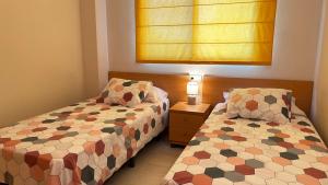 Postel nebo postele na pokoji v ubytování Apartamento Playa de Daimuz + 8 fotografií