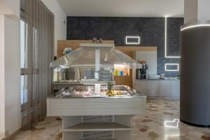 a kitchen with a counter with food in it at Hotel Continental in Caorle
