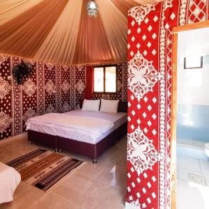 a bedroom with a bed in a tent at WADI RUM-Bedouin Tents and Jeep Tours in Wadi Rum
