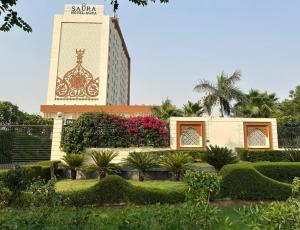 a building with a clock tower in the background at Saura Hotel, Agra in Agra