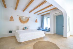 a white bedroom with a white couch and a window at Kassandra Boutique Hotel in Oludeniz