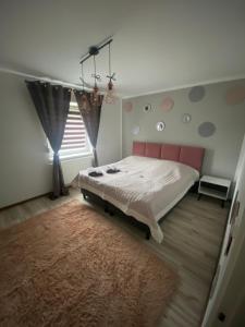 a bedroom with a large bed and a window at APARTAMENTY CIUKAJ in Paczków