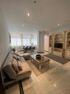 a living room with a couch and a table at Marbella Edificio Mayoral Primera Línea de Playa Centro Ciudad y Barco opcional in Marbella