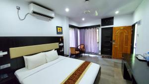 a hotel room with a bed and a desk at Kokomo Sunset Resort in Gazipur