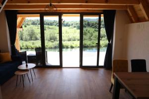 a living room with a view of a river at Bungalov La Repit in Šipovo