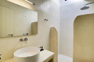 a bathroom with a white sink and a mirror at KOKOON in Parikia +97 photos