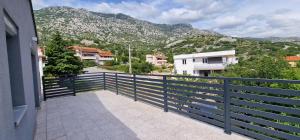 a balcony of a house with a view of a mountain at Antonija in Cesarica