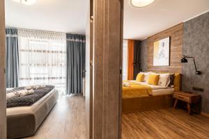 a bedroom with two beds and a window at LIKE APARTMENT in Kołobrzeg