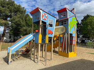 a playground with a play equipment in the sand at Lebraz 2 in Saint-Lunaire