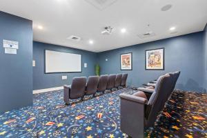 a waiting room with a row of chairs and a screen at Indigo East 1004 in Perdido Key +45 photos