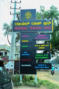 a sign for a royal rock inn on the side of a road at Royal Rock INN in Harihar