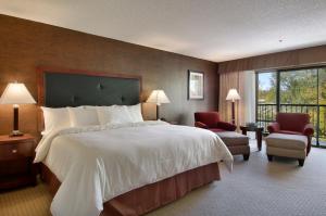a hotel room with a large bed and a balcony at Maverick Hotel and Casino by Red Lion Hotels in Elko +53 photos