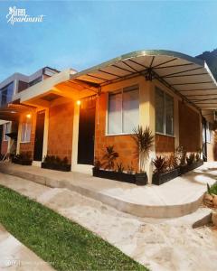 a house with a round driveway in front of it at Green Apartment el prado in Girón