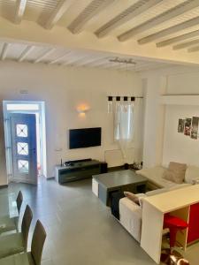 a living room with a couch and a table at Beautiful apartment in Mykonos town ! in Mýkonos City