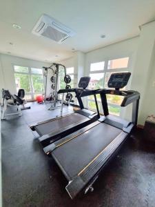 a gym with two treadmills and a treadmill at CONDO unit in Puerto Princesa Palawan in Puerto Princesa City