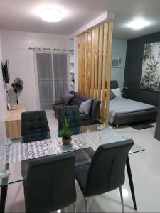 a living room with a table and a couch at CONDO unit in Puerto Princesa Palawan in Puerto Princesa City