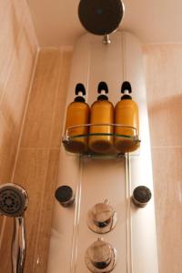a group of yellow bottles hanging from a shower at Central St Andrews 2 bed apartment in St Andrews