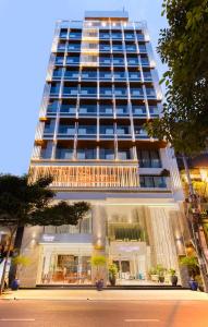 a tall building with a store in front of it at The Summer Hotel in Nha Trang