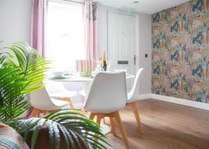 a dining room with a table and two chairs at Stylish 3x bed house in Soham in Soham