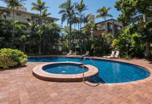 a swimming pool with a hose in a courtyard at Centrepoint Resort in Gold Coast