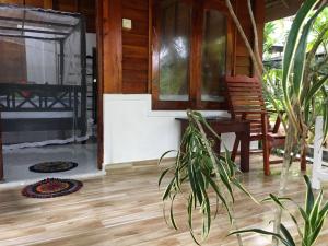un porche de una casa con una silla y una mesa en Gems Garden Guest House, en Tangalle