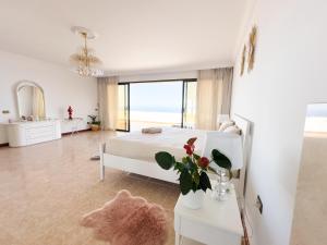 a bedroom with a bed and a view of the ocean at Villa SOHLARA in La Orotava