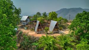 an aerial view of three houses in a forest at Monsonkeang Camping view ม่อนสันเกี๋ยง in Mae Chaem