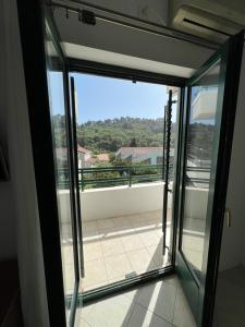 a view from the balcony of a room with sliding glass doors at Renome in Petrovac na Moru