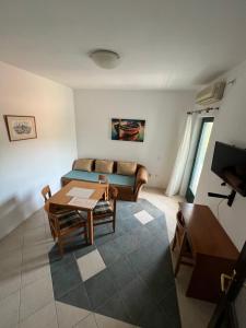 a living room with a couch and a table at Renome in Petrovac na Moru