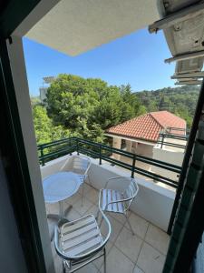 a balcony with two chairs and a table on it at Renome in Petrovac na Moru
