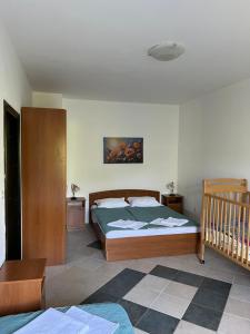 a bedroom with a bed and a crib at Renome in Petrovac na Moru