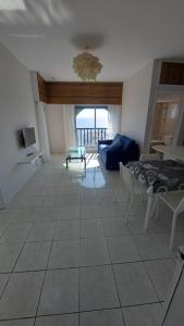 a living room with a couch and a table at Peaceful Beach Location in Limassol