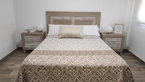 a bedroom with a large bed with two night stands at Lo Trabucador Casa nueva en el corazón del Delta in El Poblenou del Delta