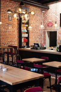 a restaurant with tables and chairs and a bar at Staycity Apartments Sukiennice 6 in Wrocław +16 photos