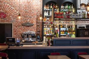 a bar in a restaurant with a brick wall at Staycity Apartments Sukiennice 6 in Wrocław