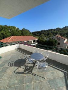 a table and two chairs sitting on a roof at Renome in Petrovac na Moru