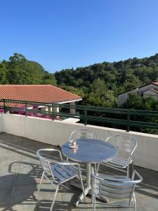 a table and chairs on a balcony with a table and chairs at Renome in Petrovac na Moru