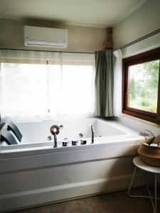 eine Badewanne in einem Zimmer mit Fenster in der Unterkunft Dolce Farnetta en-Suite Spa & Yoga in Montecastrilli