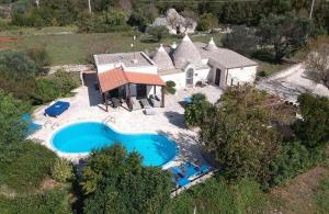 an aerial view of a house with a swimming pool at Trullo Olivia con piscina riscaldata, natura e relax in Martina Franca