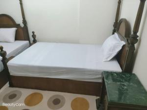 a bedroom with a bed and a table at Downtown Sea View Suites in Alexandria