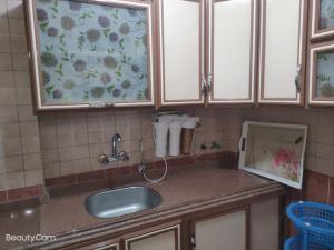 a kitchen counter with a sink and a window at Downtown Sea View Suites in Alexandria +28 photos