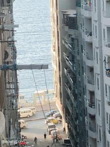 a view of a street between two tall buildings at Downtown Sea View Suites in Alexandria
