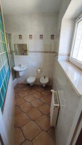 a bathroom with two sinks and two toilets at Pokoje w Mielnie "Polikarp" in Mielno