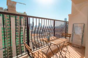 a balcony with a table and chairs on a balcony at Fully Furnished Studio In JVC RL in Dubai