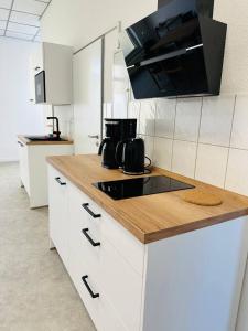 a kitchen with white cabinets and a counter top at Dill Apartments Ilsede in Ilsede