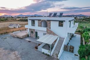 an aerial view of a house with a sunset at Aurora apartments Room 1 in Marmari
